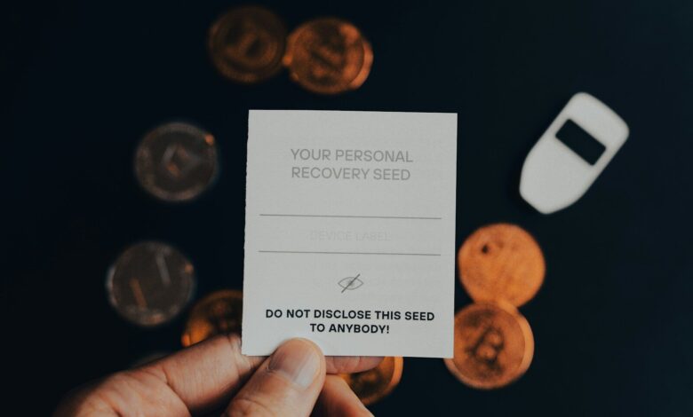 a person holding a business card in front of a pile of coins