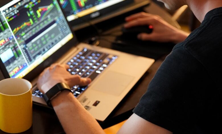 man sitting in front of the laptop