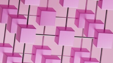 a bunch of pink cubes hanging from a pink wall