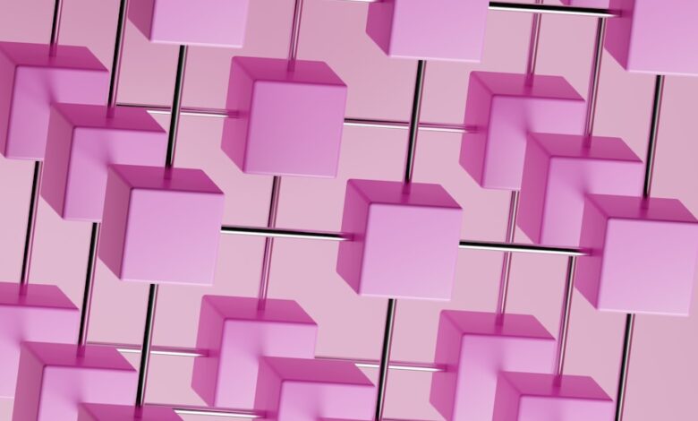 a bunch of pink cubes hanging from a pink wall