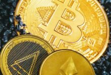 a bitcoin sitting on top of a pile of coins